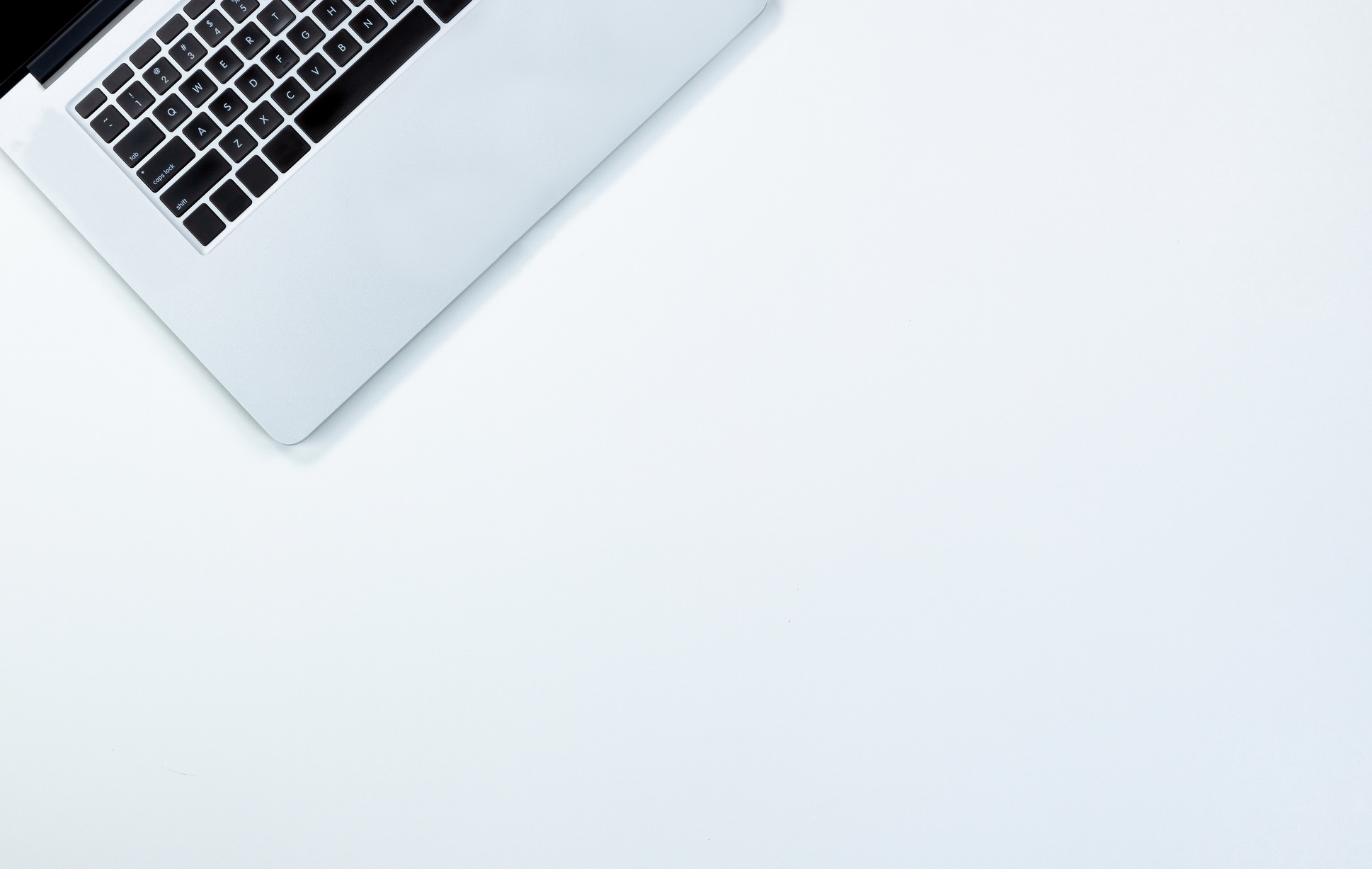 Clean white desktop with mobile computer